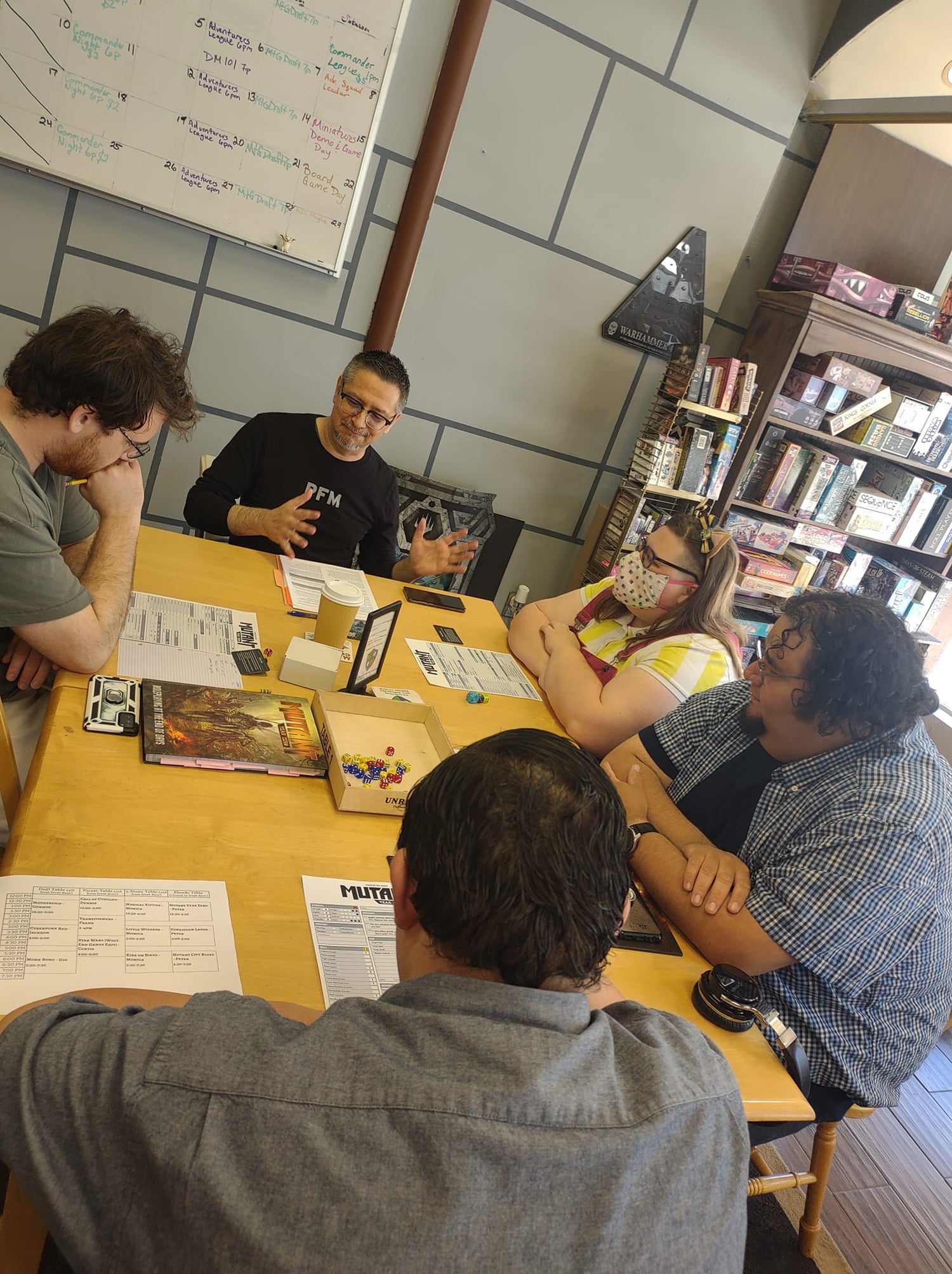 Avid gamers playing a tabletop board game at The Guild House in Cerritos, California